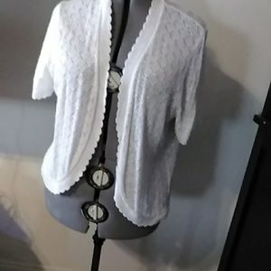 White shrug with scallops on the edge